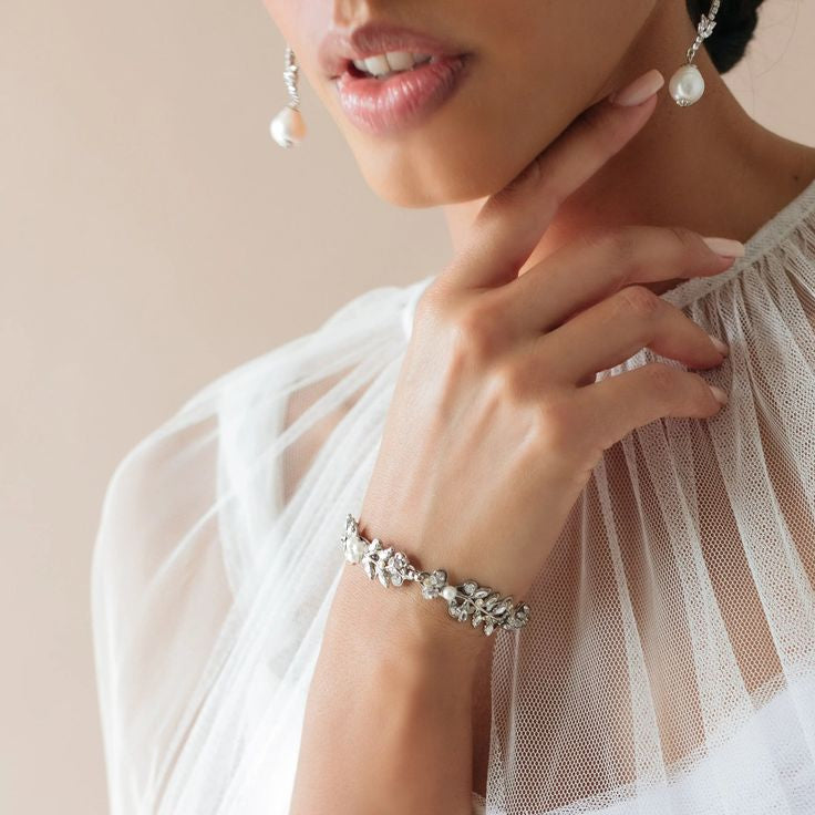 Woman wearing a bracelet with a neutral background